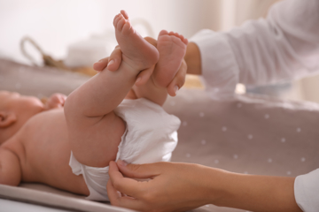 Woman changing diaper on a baby