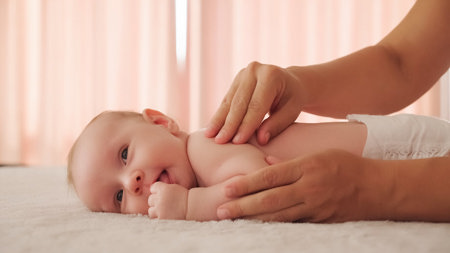 Woman massaging a baby